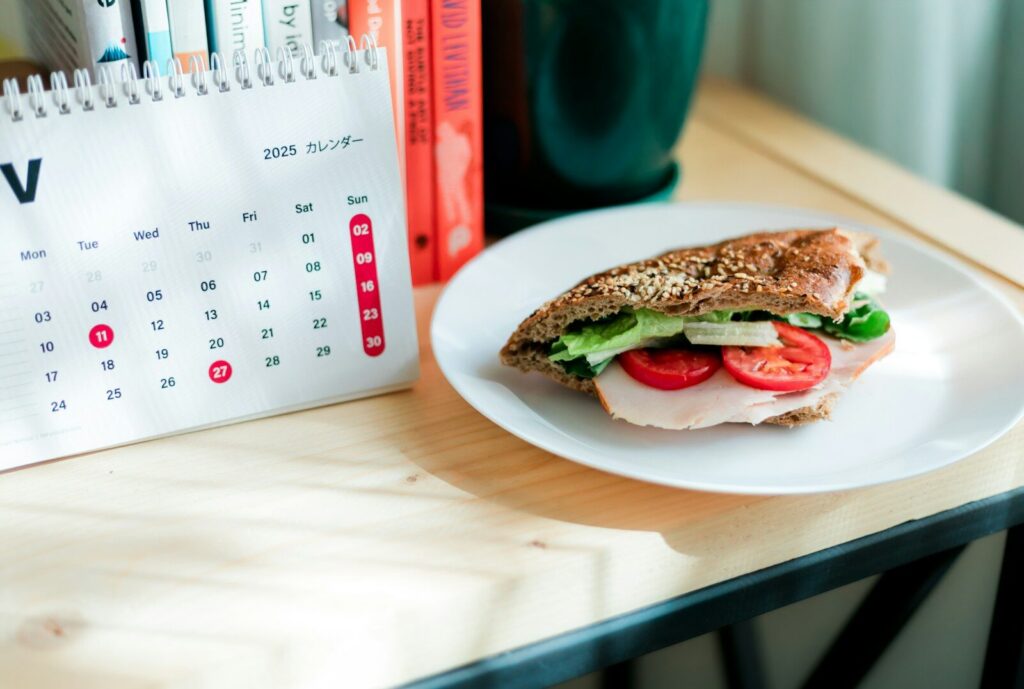 Sandwich with tomato and lettuce on a desk